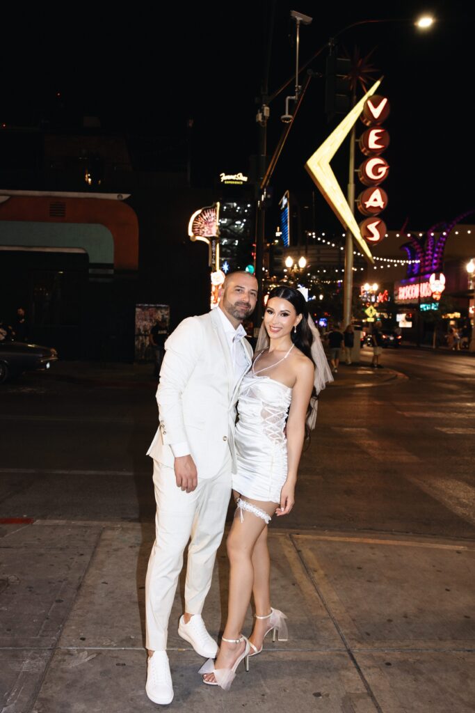 Bride and groom posing on Fremont Street in Las Vegas