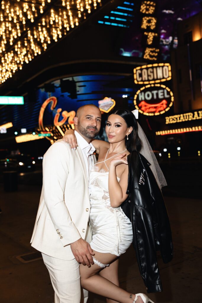 Bride and groom posing on Fremont Street during their Las Vegas elopement