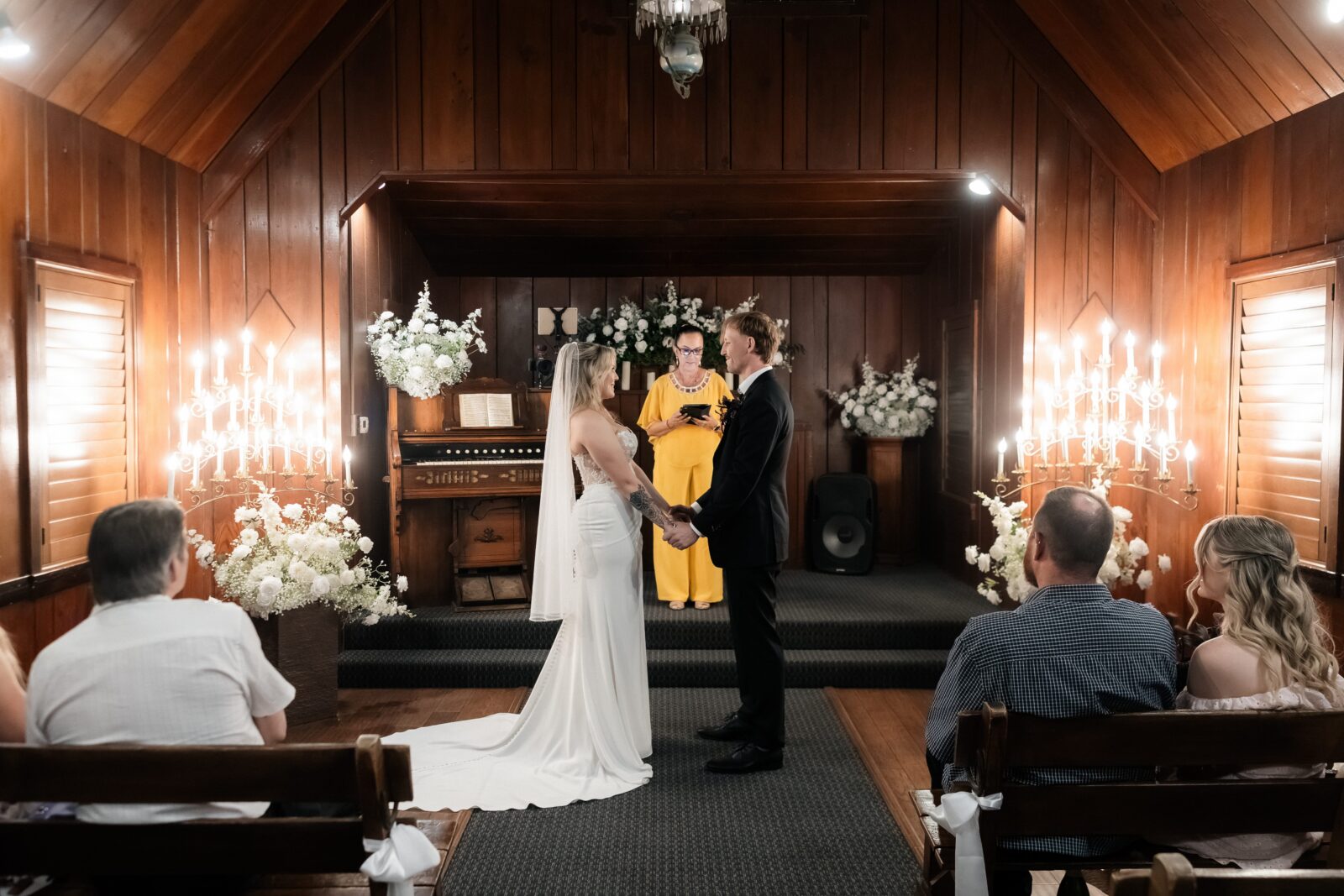 Bride and groom holding hands during their Las Vegas wedding ceremony at The Little Church of The West.