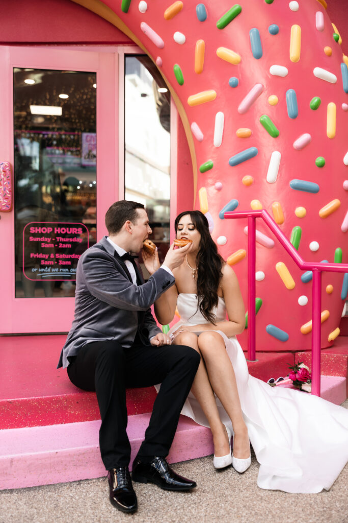 Bride and groom feeding each other donuts in Las Vegas