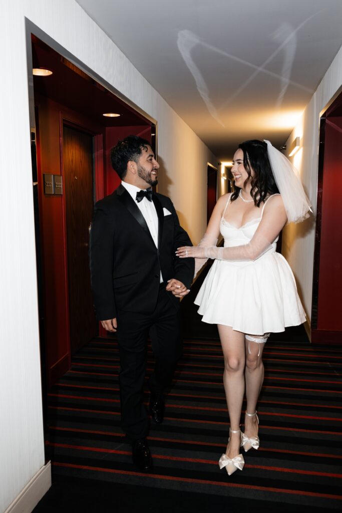 Bride and groom walking the hallways at d Hotel & Casino for their Las Vegas elopement photos