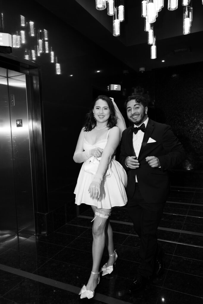 Black and white photo of a bride and groom walking the hallways of the D Hotel & Casino in Las Vegas