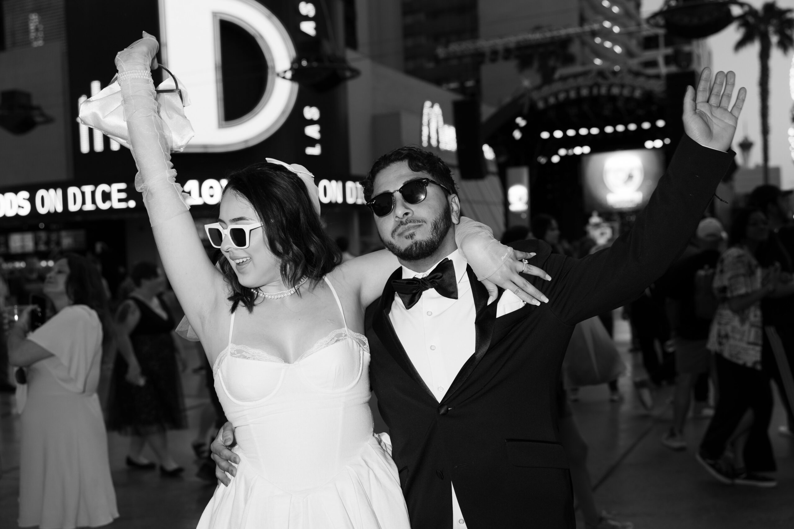 Black and white photo of a bride and groom in downtown Vegas for their fun elopement