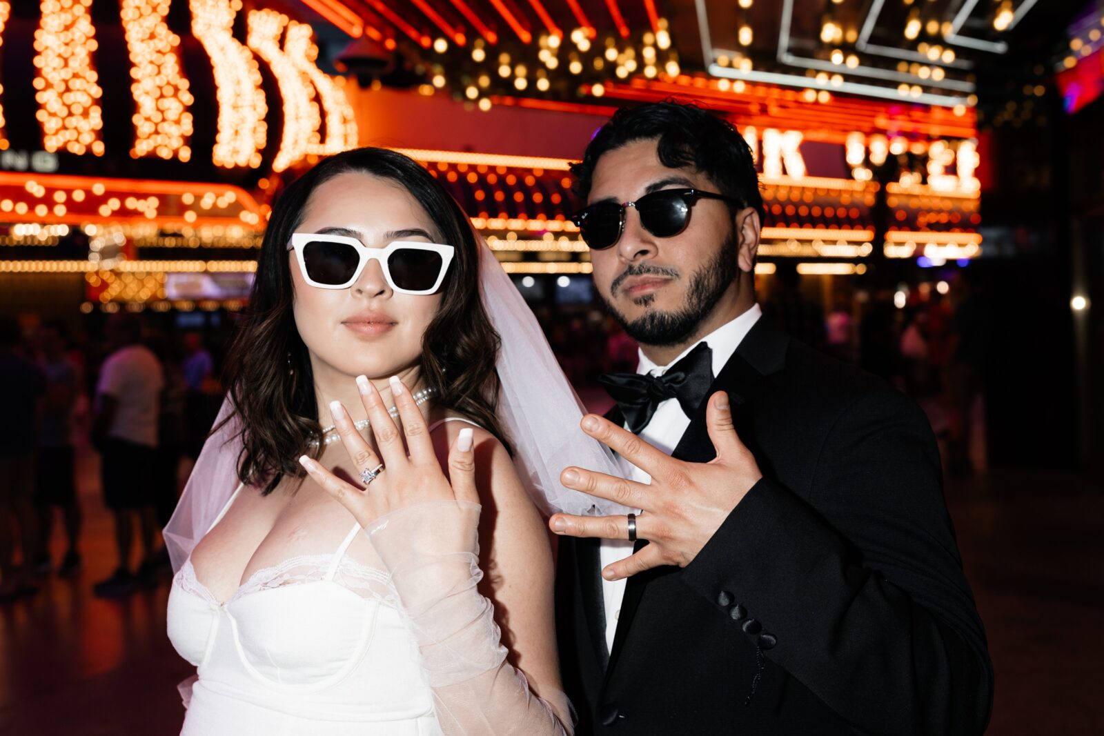 Bride and groom posing in front of the D Hotel & Casino during their fun elopement in Vegas