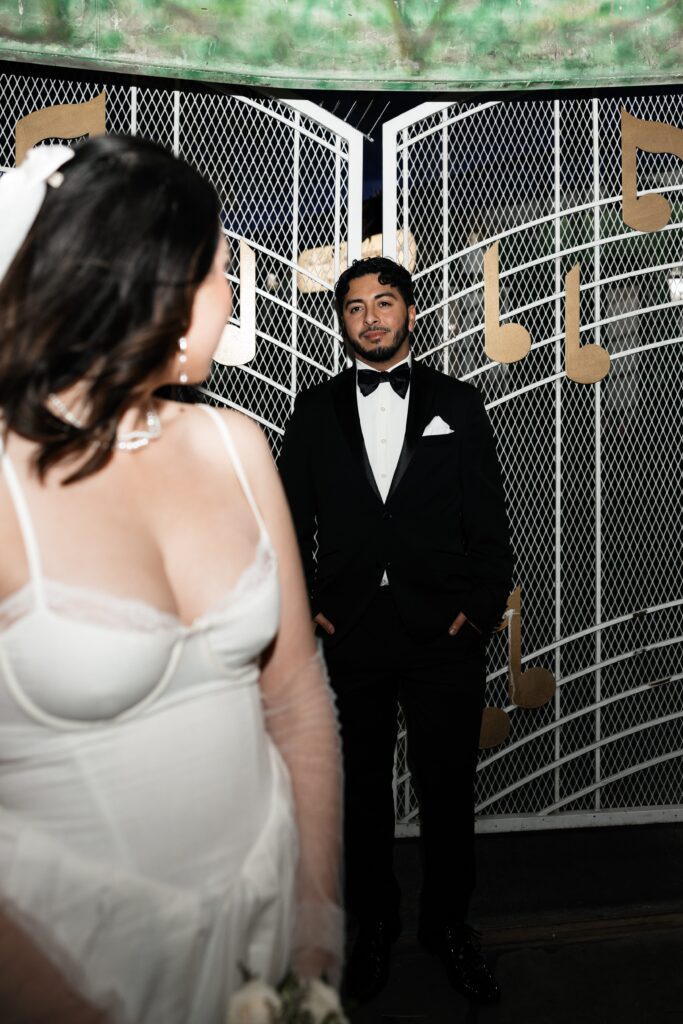 Bride and grooms flash elopement photos at night at The Little White Wedding Chapel