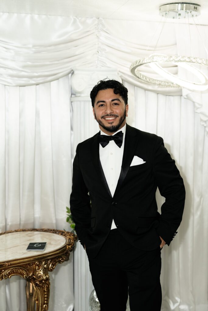 Groom smiling as his bride walks down the aisle