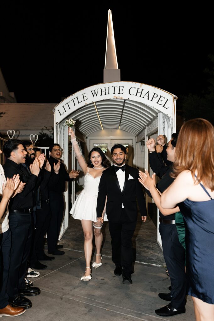 Bride and groom exiting out of The Little White Wedding Chapel after their ceremony