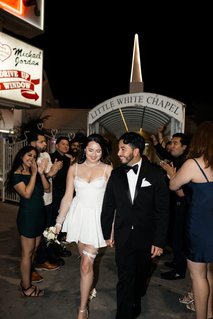 Bride and groom exiting out of The Little White Wedding Chapel after their ceremony