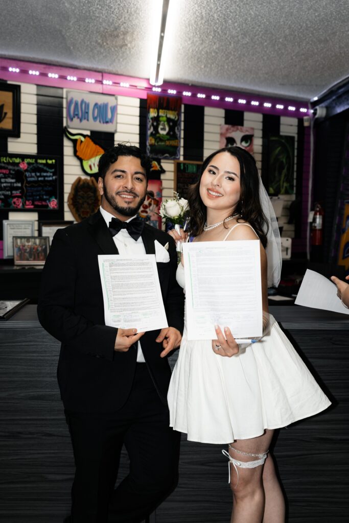 Bride and groom signing a contract for their Las Vegas elopement tattoos