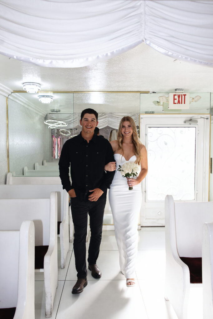 Bride and groom walking down the aisle together at Little White Wedding Chapel during their Las Vegas elopement