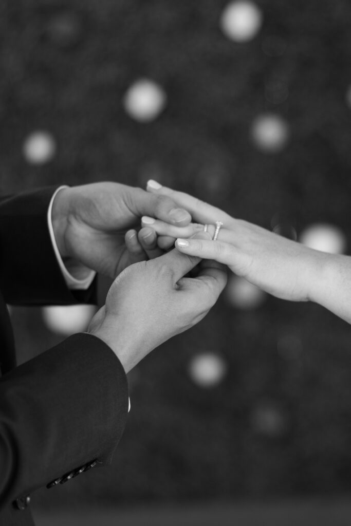 Groom putting the ring on his brides finger