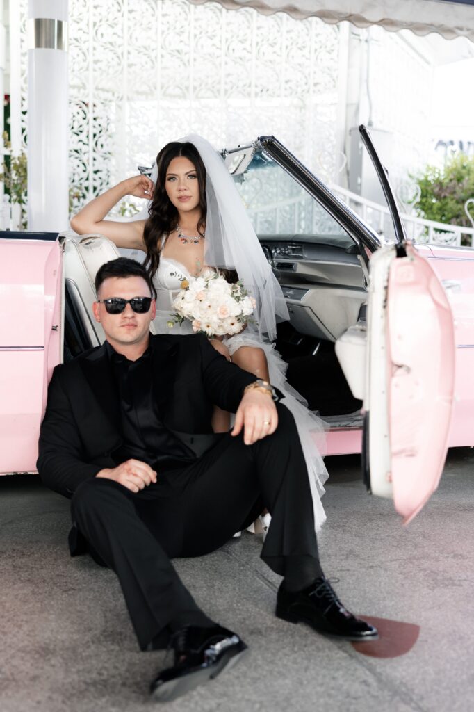 Bride and grooms Las Vegas elopement portraits in the Pink Cadillac at The Little White Wedding Chapel