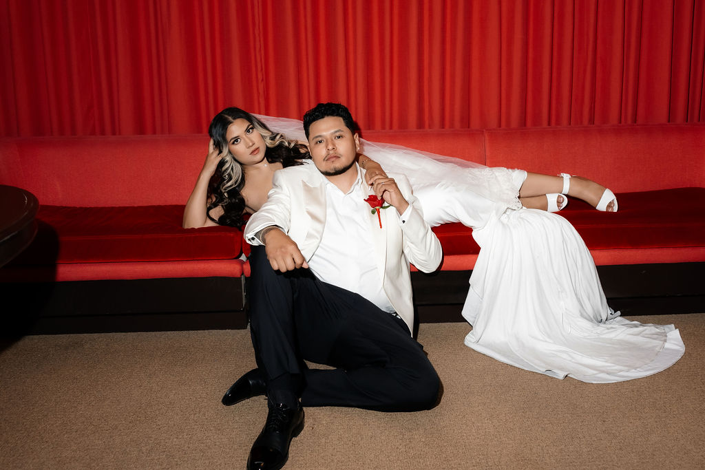 Editorial bride and grooms elopement portraits in a red room with red seating