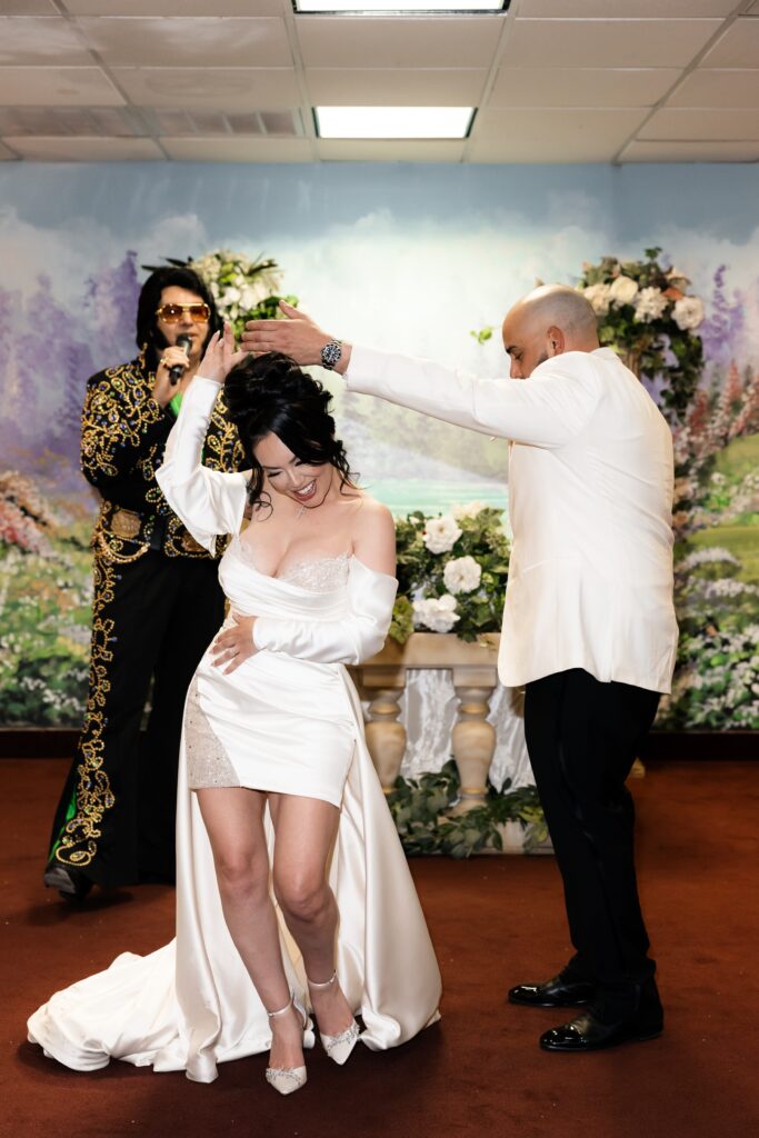 Bride and groom dancing in Chapel Amore as the Elvis impersonator sings to them during their Elvis wedding ceremony at The Little White Wedding Chapel