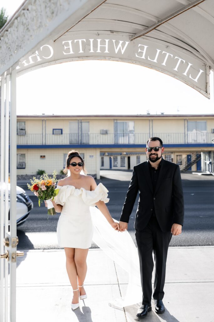 Bride and groom holding hands at The Little White Chapel in Las Vegas