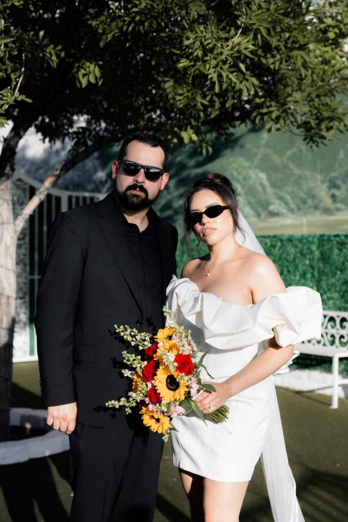 Bride and groom posing for their outdoor elopement photos at The Little White Wedding Chapel