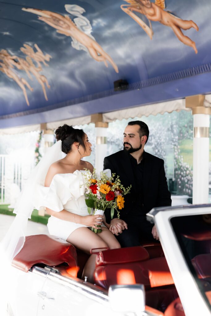 Bride and grooms intimate Little White Chapel elopement ceremony with a 1985 Cadillac El Dorado