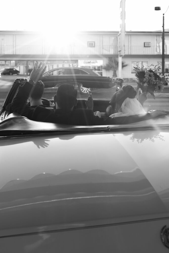 Bride and groom driving out of The Tunnel of Love after their ceremony