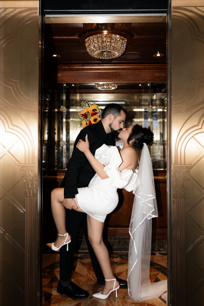 Flash elopement photo of a bride and groom kissing in a hallway elevator at The Venetian