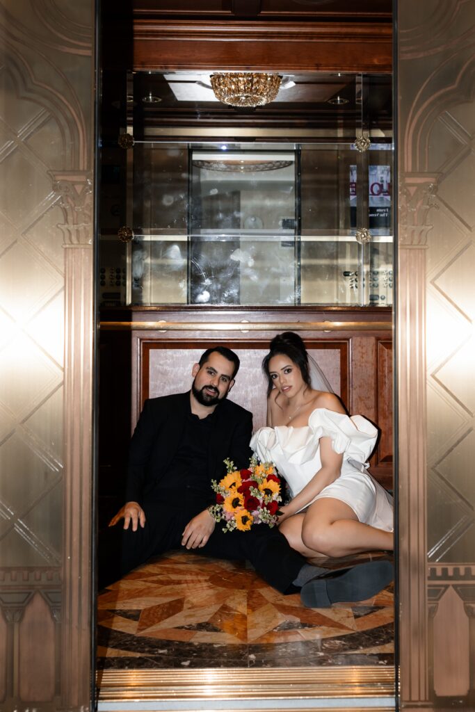 Bride and groom sitting in an elevator at The Venetian