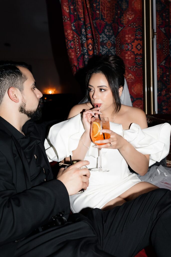 Bride and groom having cocktails during their Las Vegas elopement in The Shag Room at Virgin Hotel