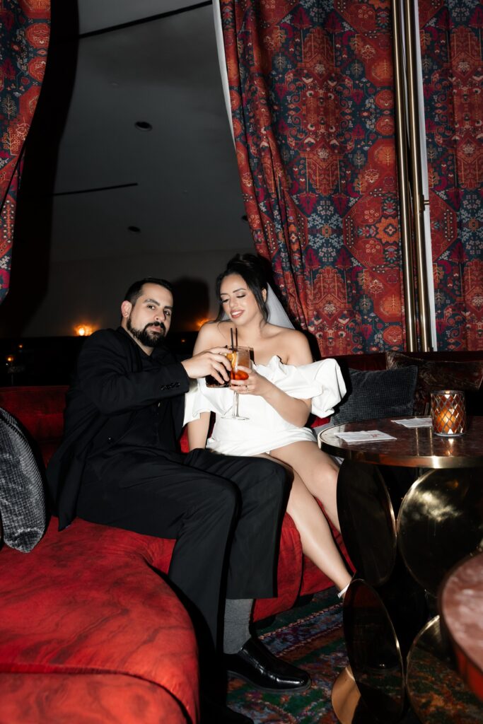 Bride and groom having cocktails during their Las Vegas elopement in The Shag Room at Virgin Hotel