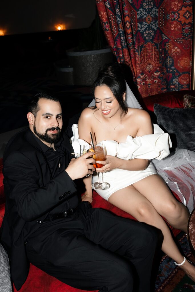 Bride and groom having cocktails during their Las Vegas elopement in The Shag Room at Virgin Hotel