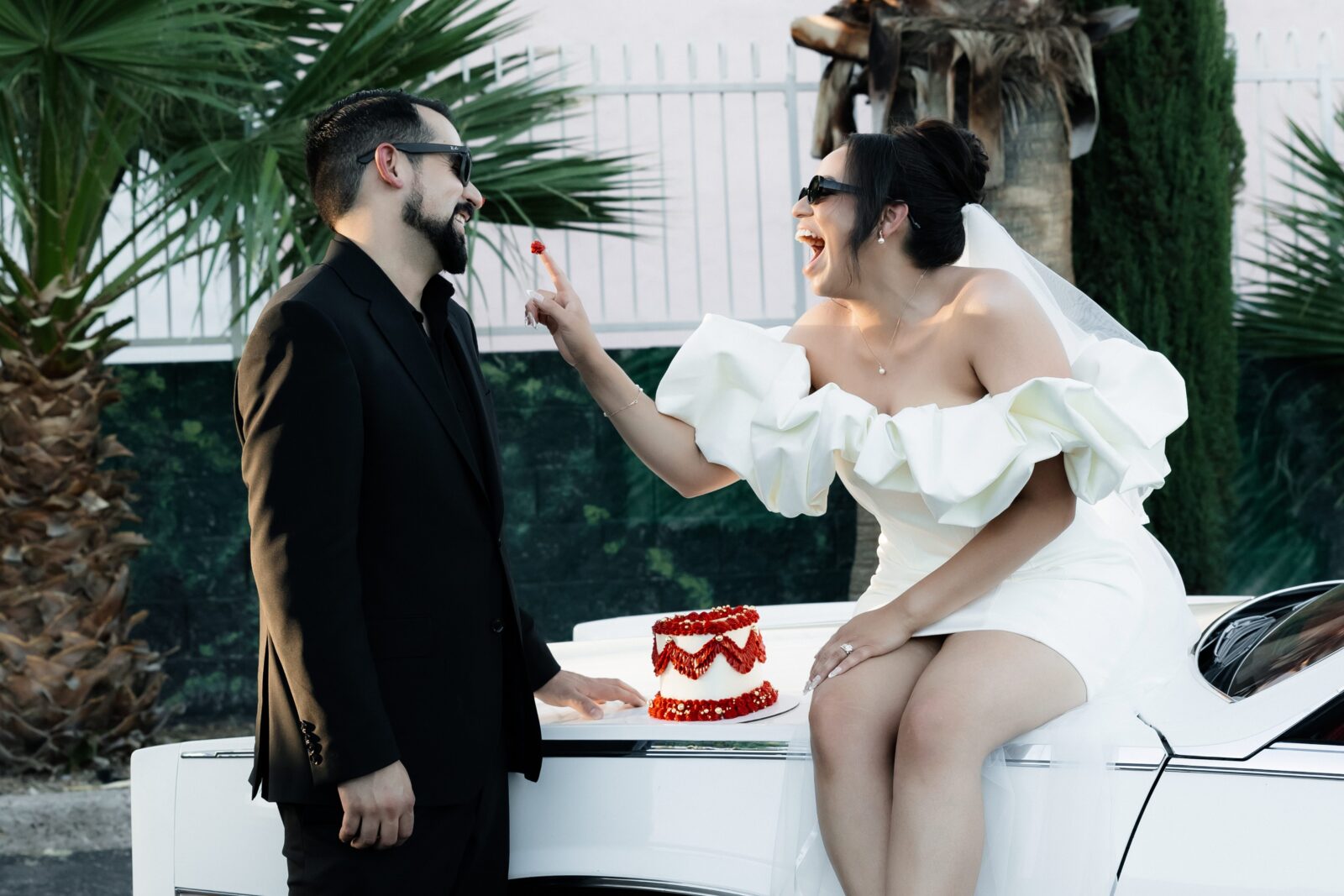 Bride feeding her groom frosting off of their cake