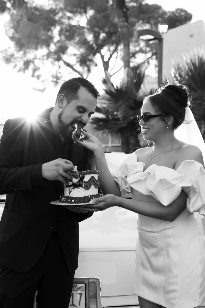 Bride feeding her grooms bites from their elopement cake