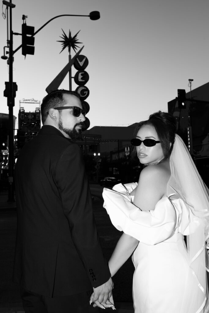 Black and white bride and grooms Las Vegas elopement photos with the vintage neon sign