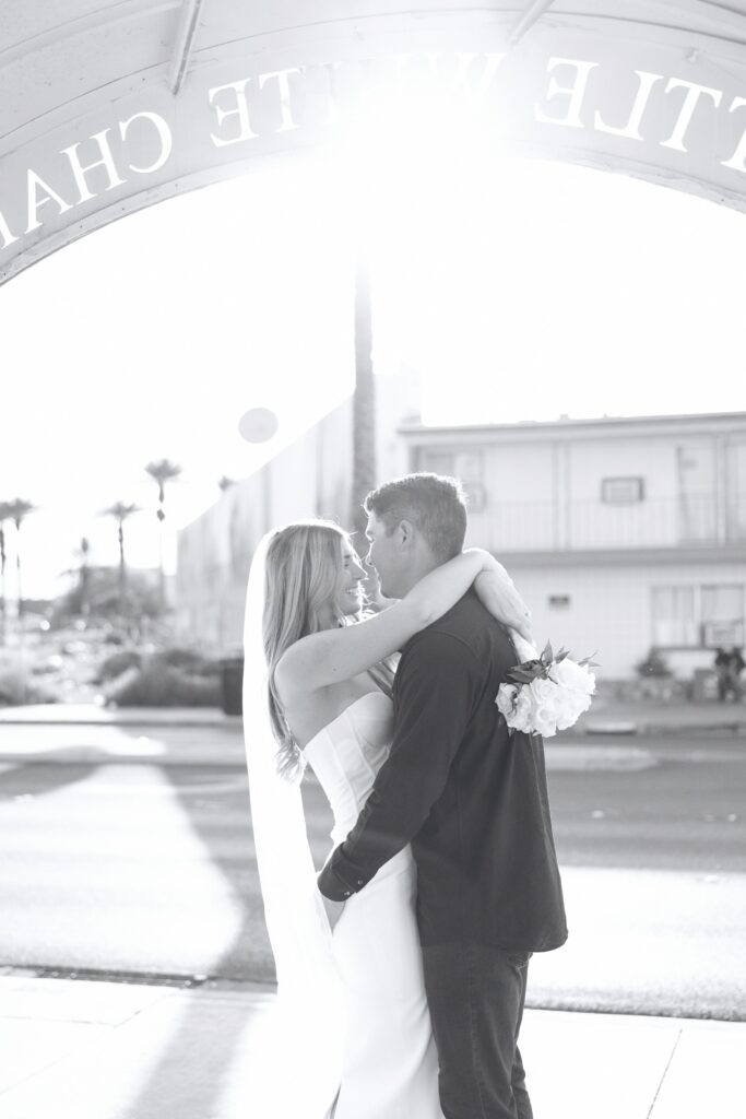 Black and white photo of a bride and groom posing for portraits