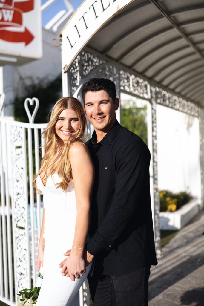 Bride and groom posing for portraits at The Little White Wedding Chapel in Las Vegas