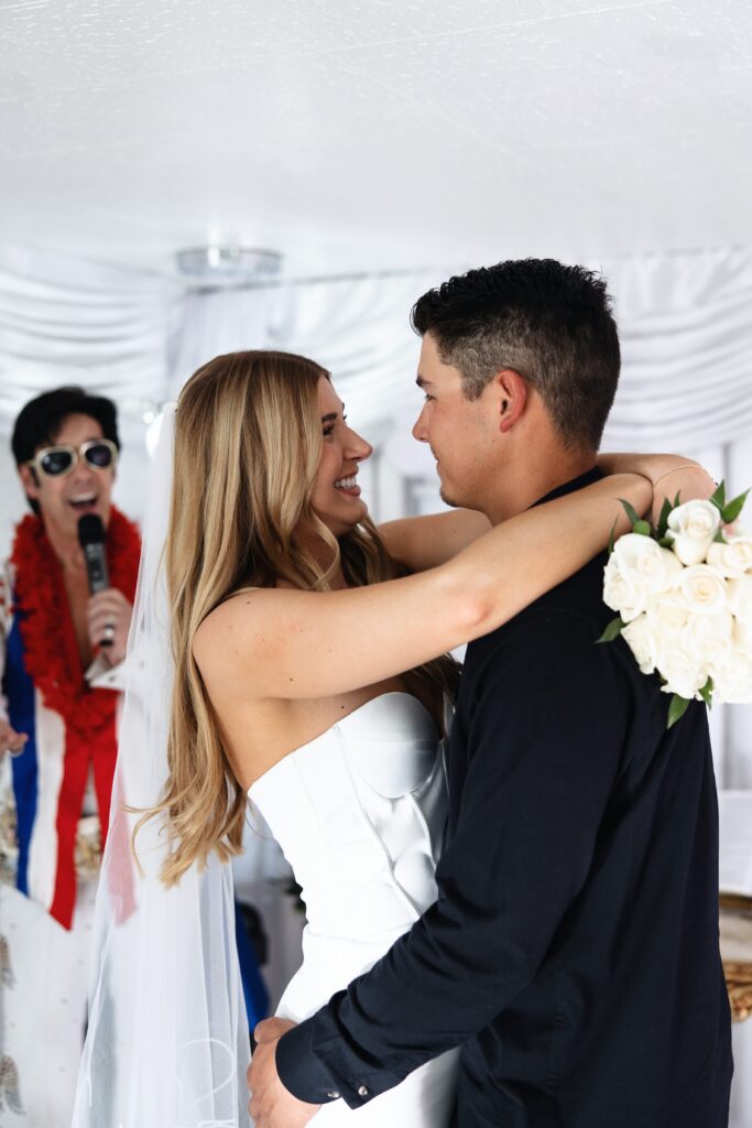 Bride and groom dancing while Elvis serenades to them during their Little White Chapel elopement in Las Vegas