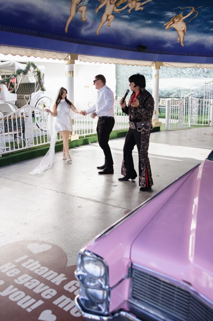 Bride and groom being serenaded to by the Elvis impersonator