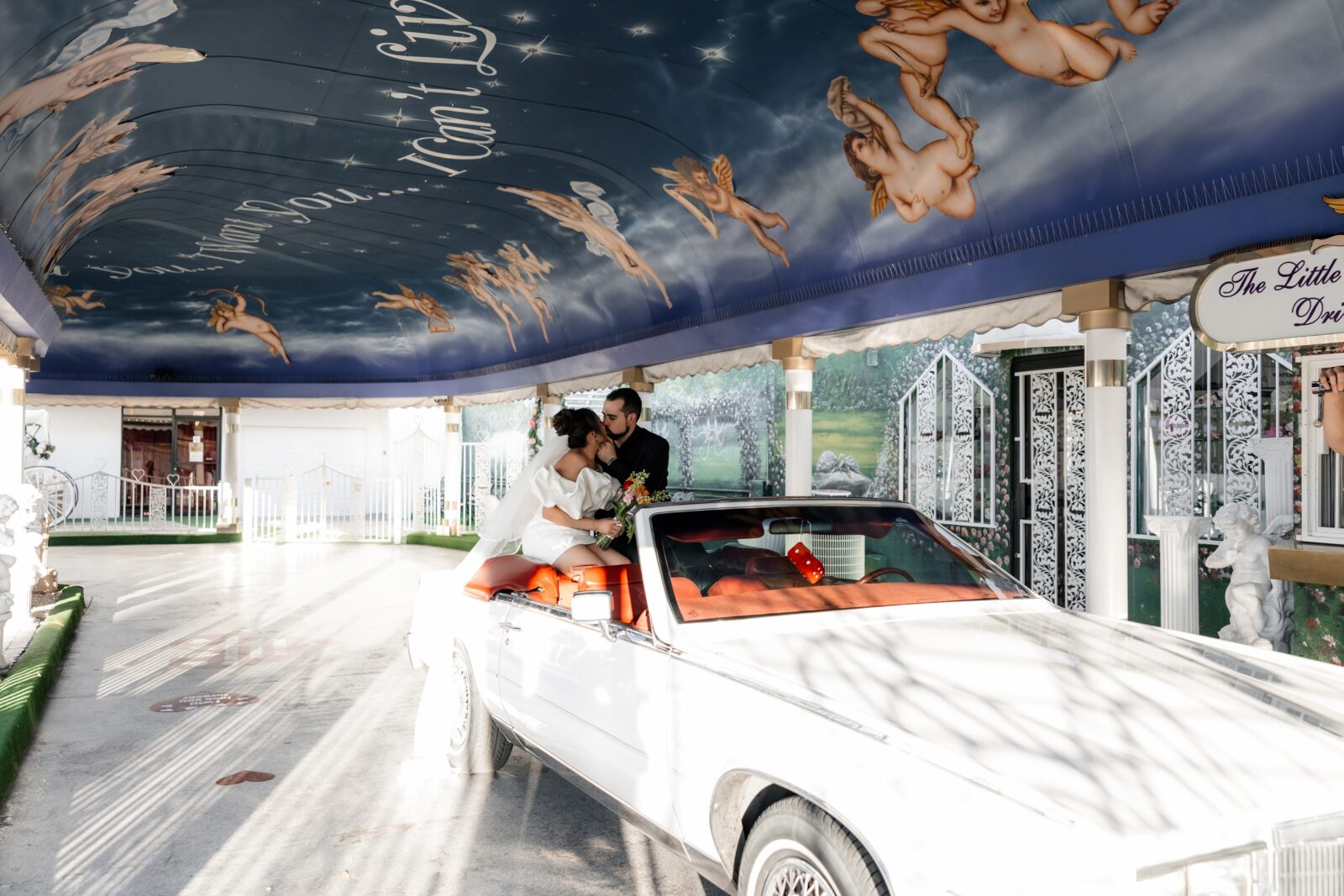 Bride and groom kissing in The Risky Ride during their Little White Wedding Chapel Las Vegas elopement