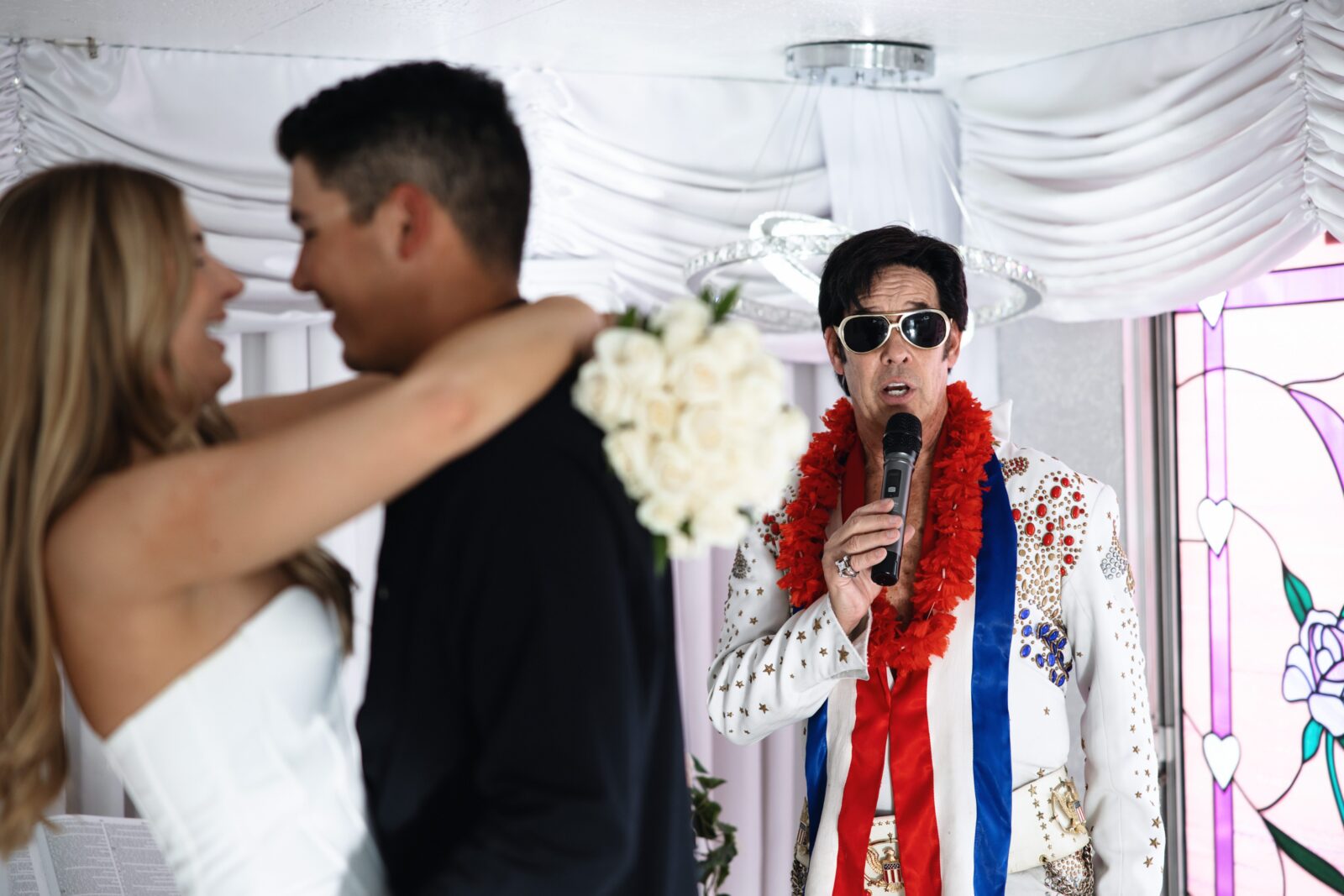 Bride and groom dancing during their Little White Wedding Chapel elopement as their being serenaded to by Elvis