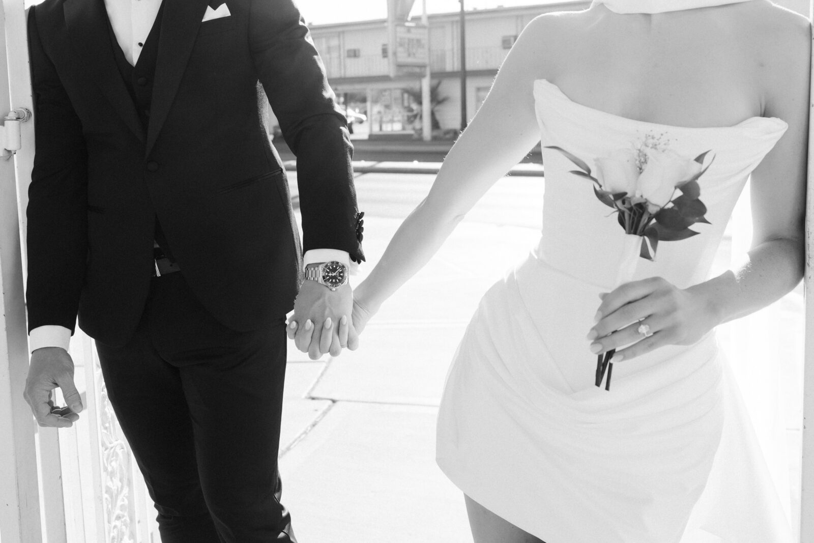 Black and white close up shot of a couple holding hands in Las Vegas.