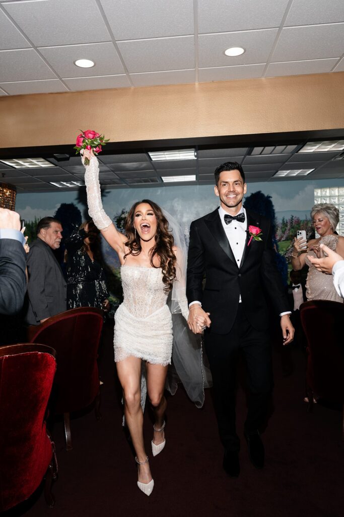 Bride and groom walking back down the aisle as husband and wife at Chapel Amore at The Little White Wedding Chapel.