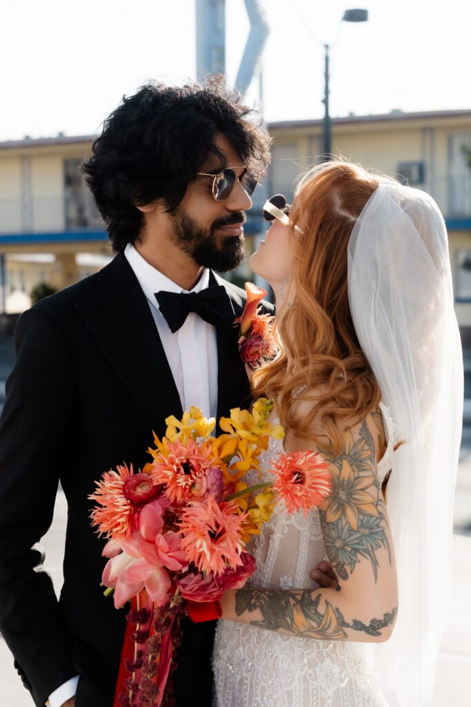 Close up shot of a bride and groom smiling at each other.