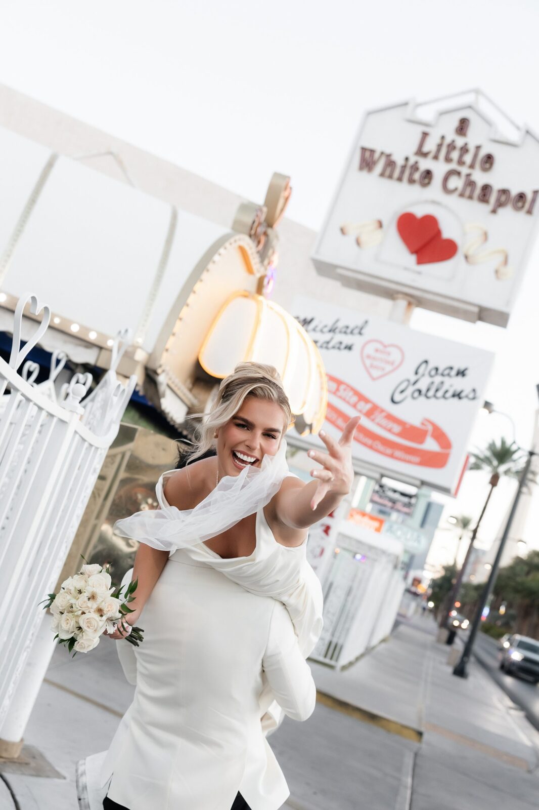 Bride and groom posing outside of The Little White Wedding Chapel in Las Vegas.