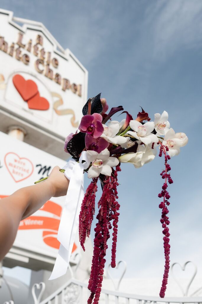 Bride holding up her bouquet for her Little White Chapel elopement photos.