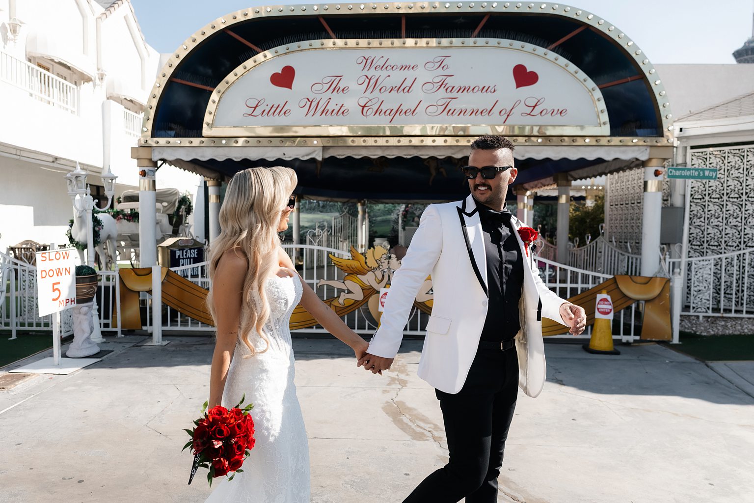 Bride and groom walking outside of The Little White Chapel in Las Vegas.