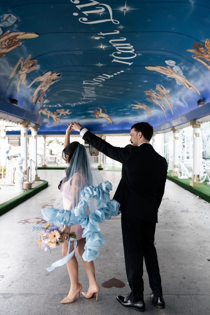 Groom twirling his bride in The Tunnel of Love.