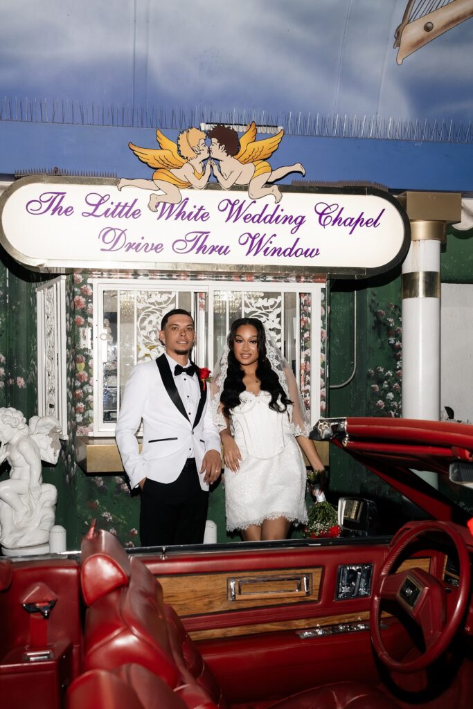 Bride and groom posing in the Tunnel of Love at the Dive Thru window in Las Vegas.