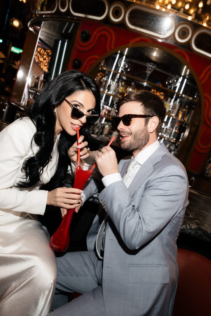 Bride and groom sipping a cocktail at Carousel Bar on Fremont Street in Las Vegas.