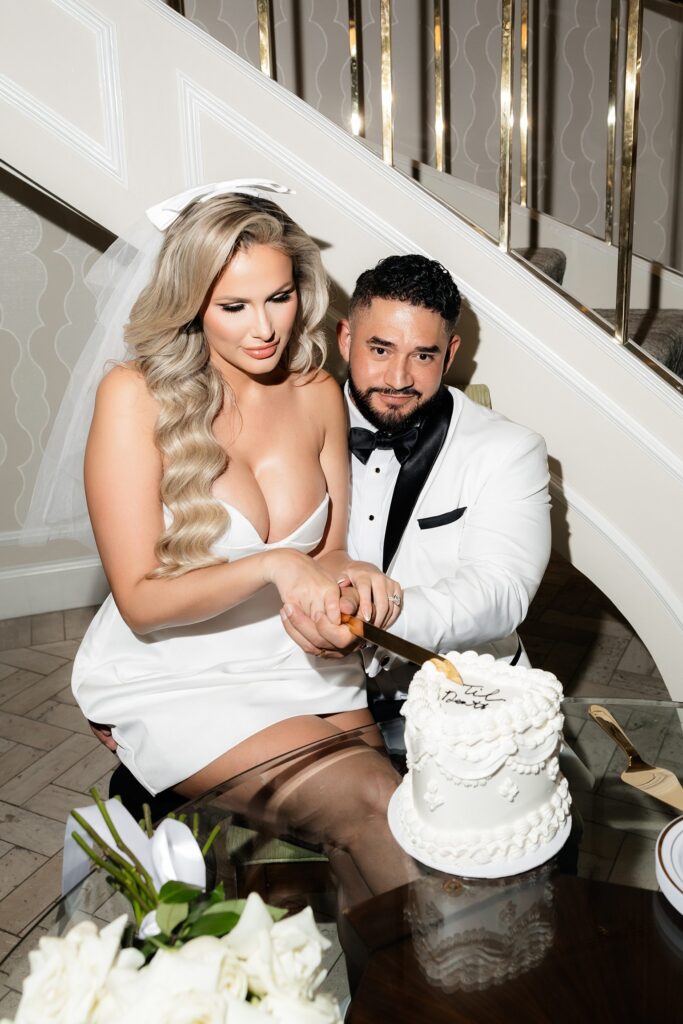 Bride and groom cutting into their heart shaped elopement cake