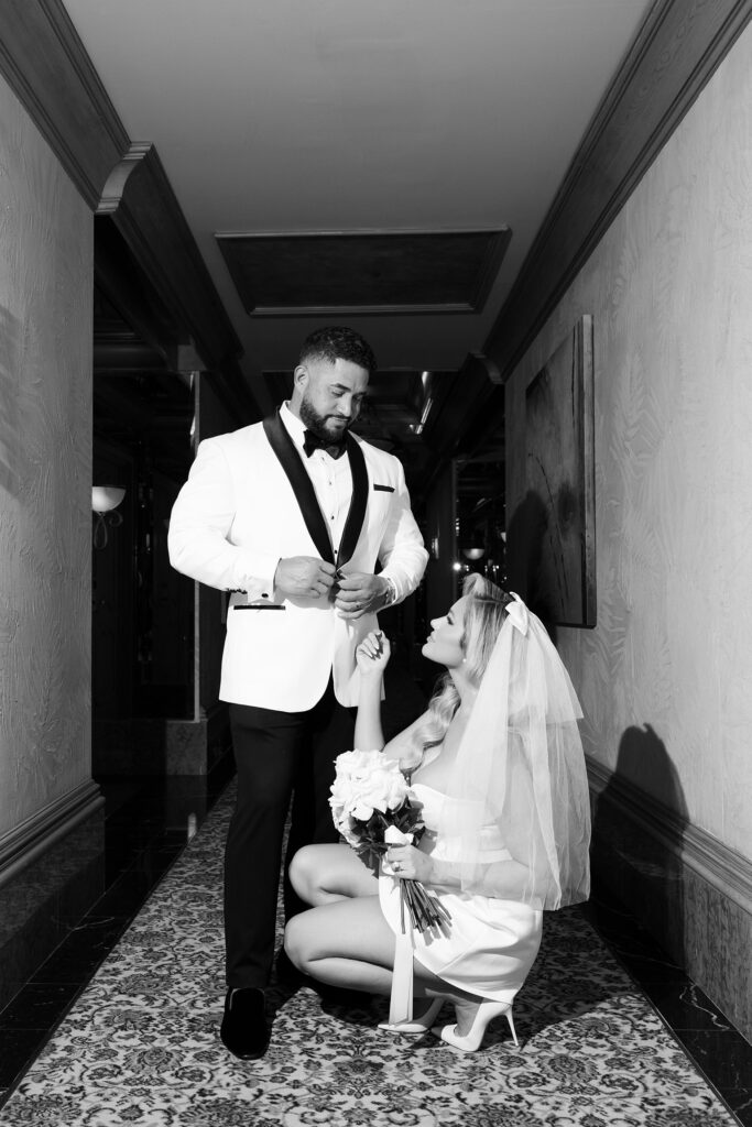 Black and white photo of a bride and groom posing in the hallway of Golden Nugget in Las Vegas