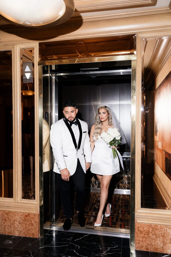 Flash photo of a bride and groom walking out of an elevator at Golden Nugget in Las Vegas