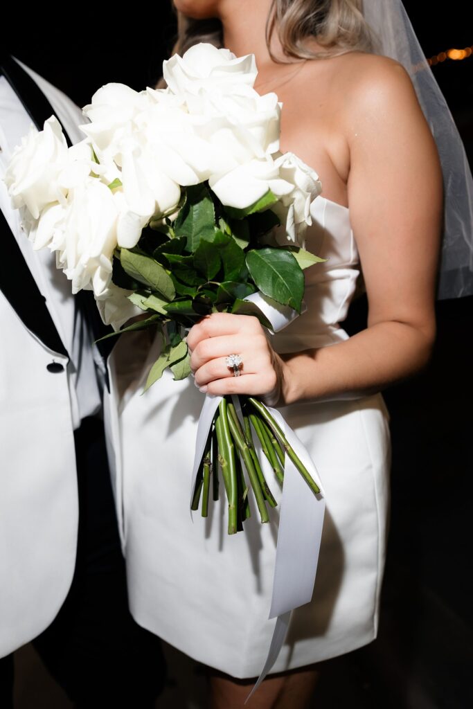 Flash photo of a bride holding her wedding bouquet