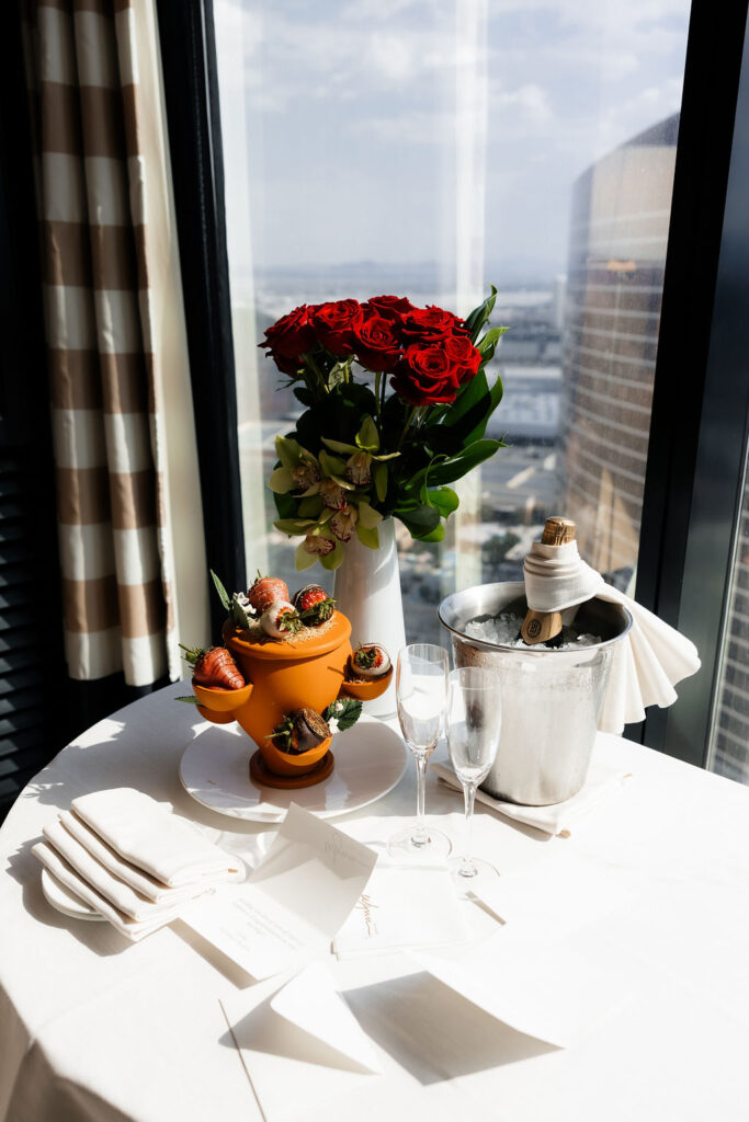 Bride and grooms Las Vegas hotel elopement set up with champagne and chocolate covered strawberries